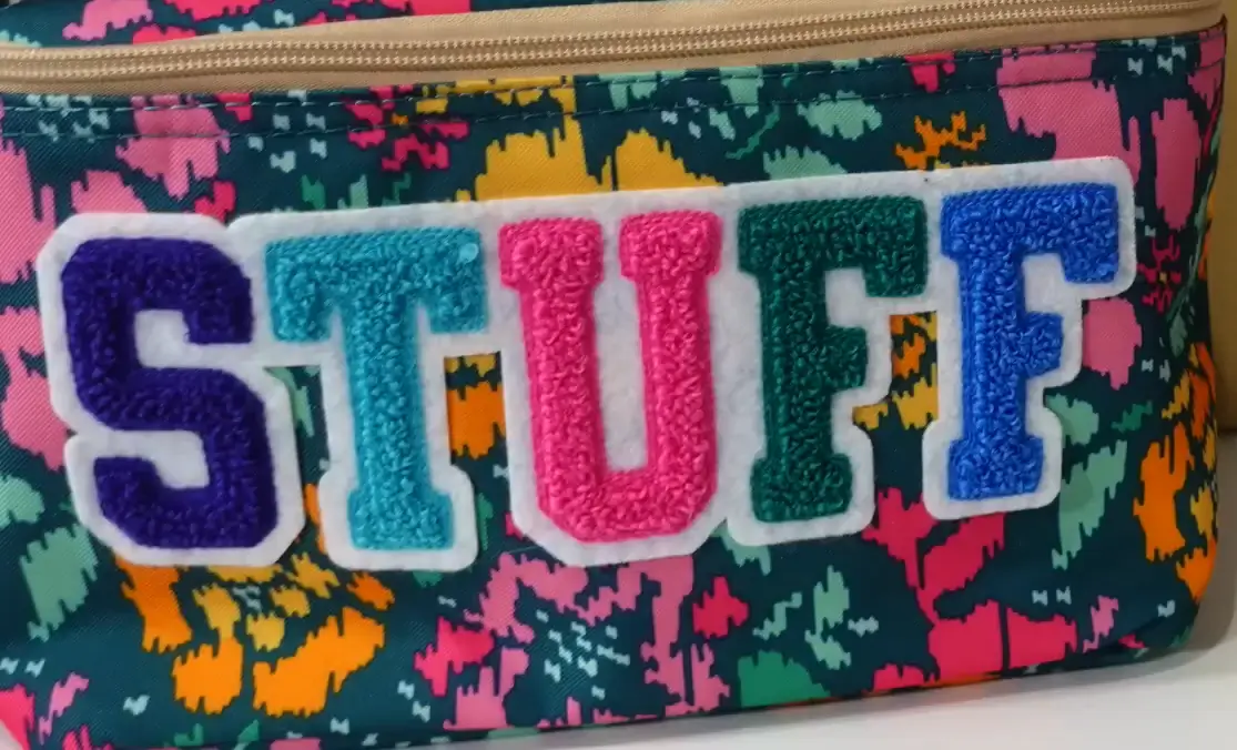 Close up of a Chenille 'STUFF' patch showing fuzzy, towel-like 3D texture and volume.