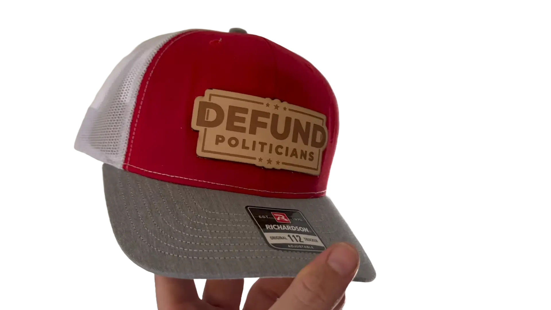 leather patch applied to a Richardson 112 trucker hat showing embossed design on front panel