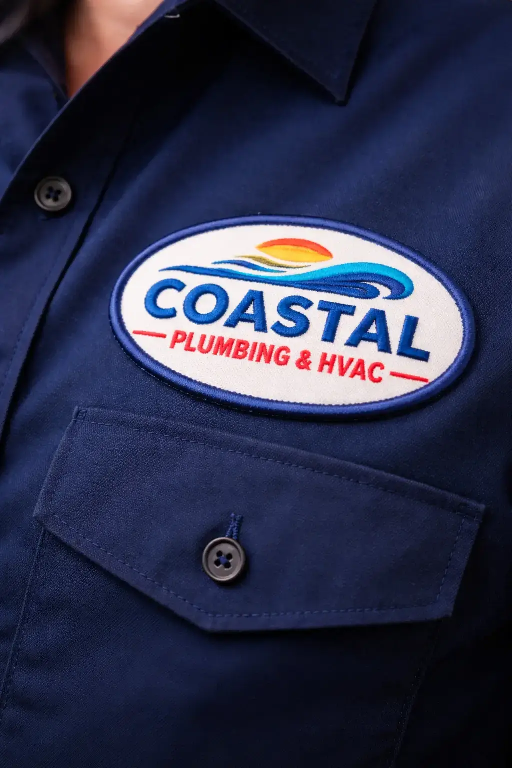 Custom embroidered company patch on work uniform shirt