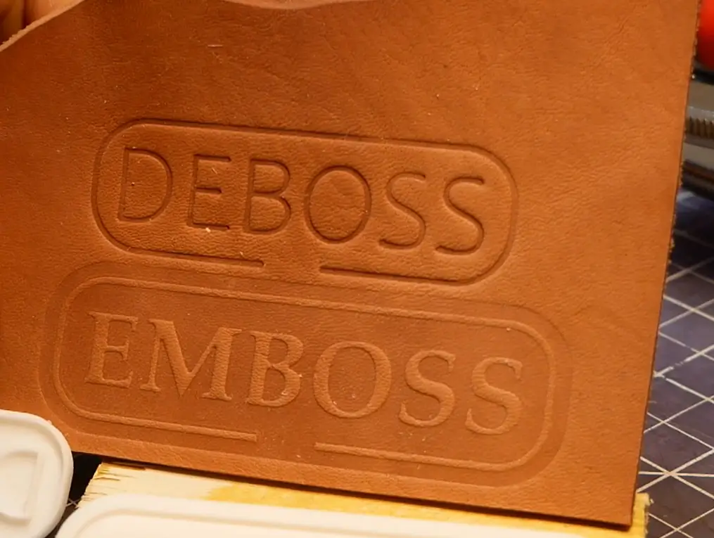 Close-up comparison of debossed and embossed text on genuine leather showing depth and texture difference