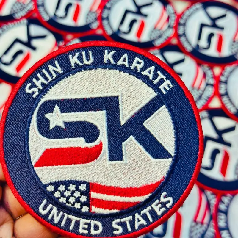 Angled view of a custom karate patch highlighting the durable red merrowed border and thick embroidery.