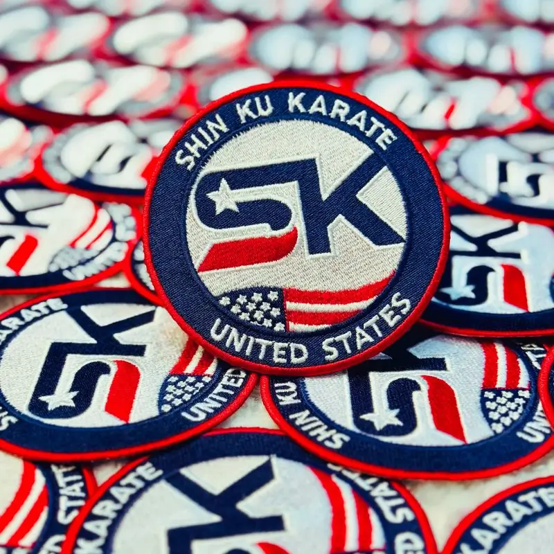 Close-up of Shin Ku Karate embroidered patch showing high-detail USA flag stitching and texture.