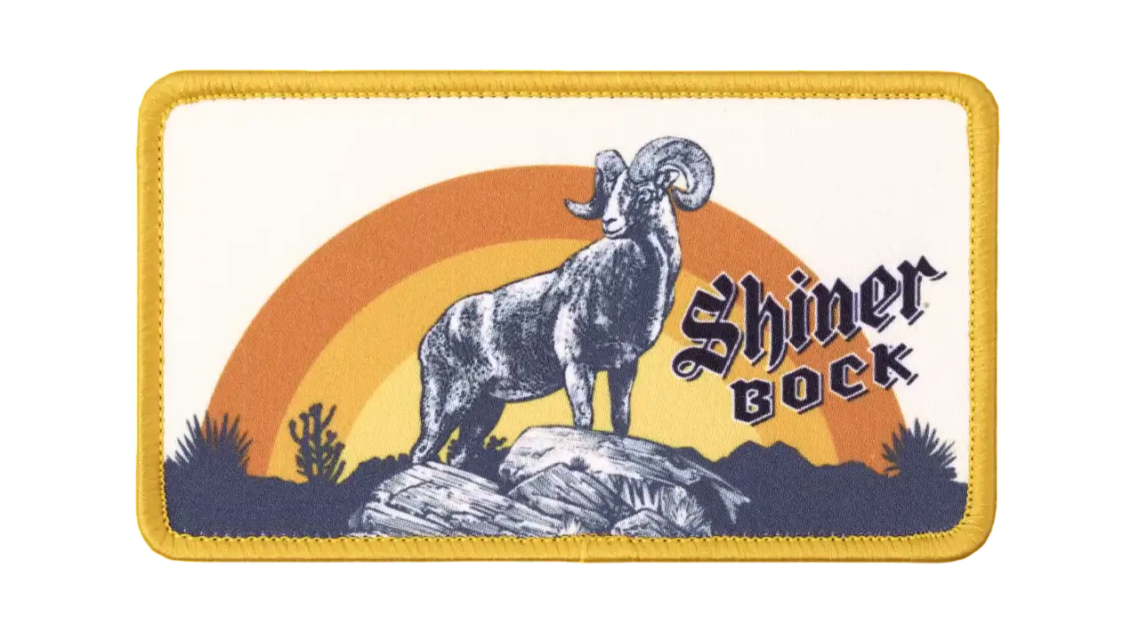 Rectangular custom dye-sublimated patch showing a ram on rocks with an orange-yellow sunset and 