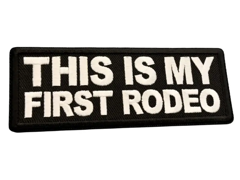Black embroidered patch with white text reading 'this is my first rodeo'