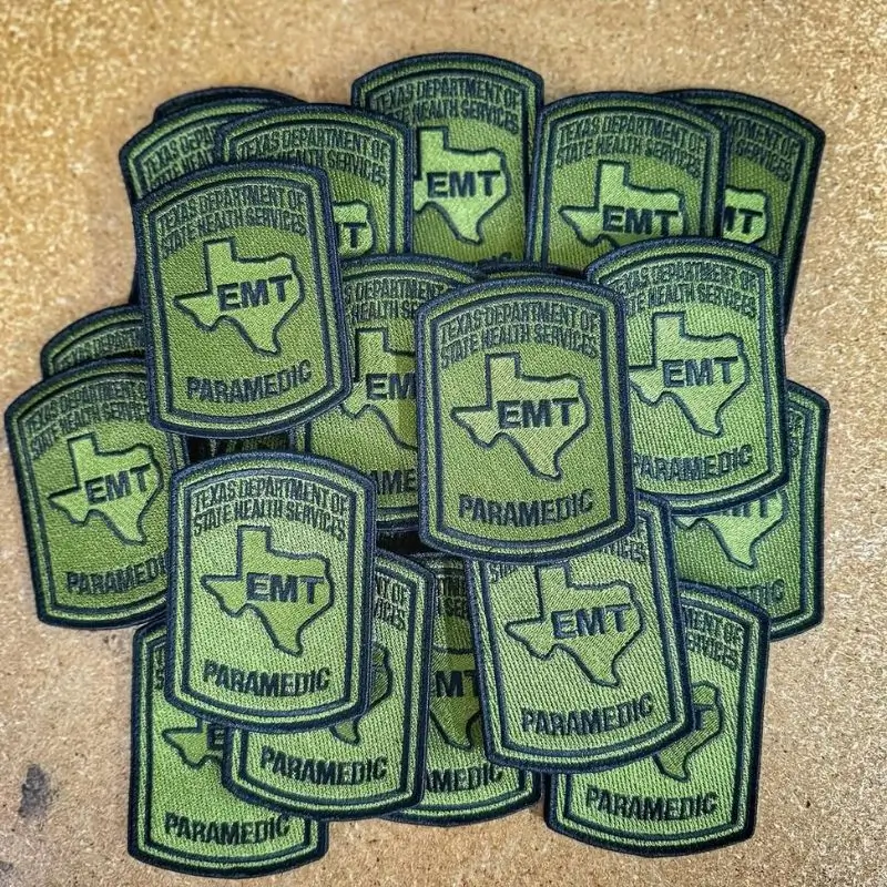 Official green and black embroidered uniform patches for Texas EMTs and Paramedics featuring the Texas state outline.